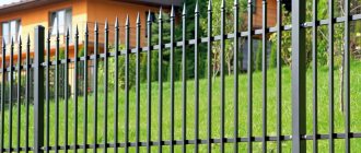 Fence from a profile pipe on a suburban area